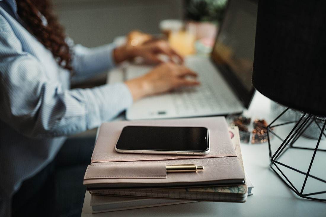 Person working on a laptop at a desk